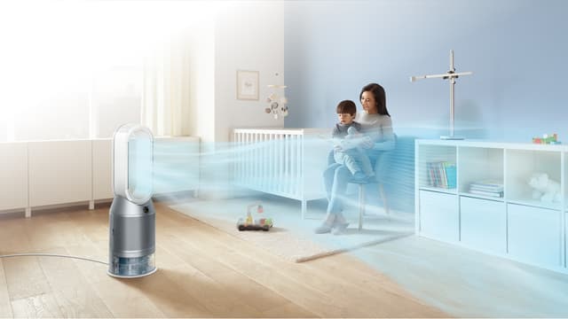 Woman and boy sitting on a chair in a childs room