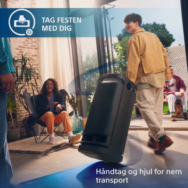 Sony SRS-XV900 trådløs og transportabel højtaler trukket af mand som ankommer til glade mennesker
