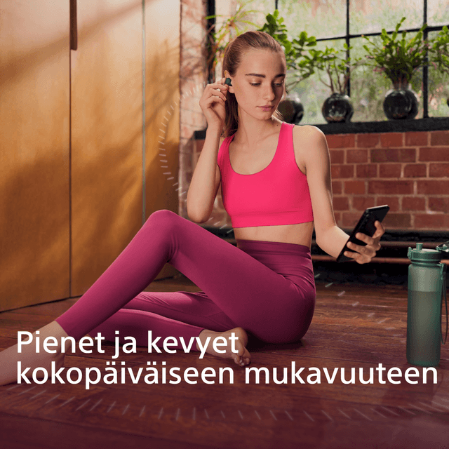 Joogavaatteisiin pukeutunut tyttö Linkbuds-kuulokkeet korvissaan