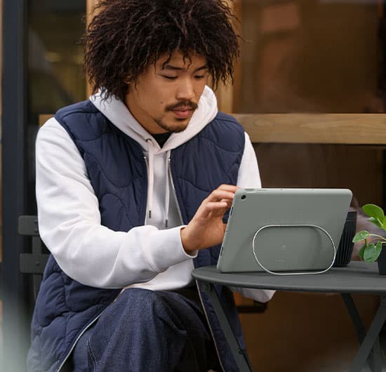 Mann som sitter ute og bruker Google Pixel-nettbrettet