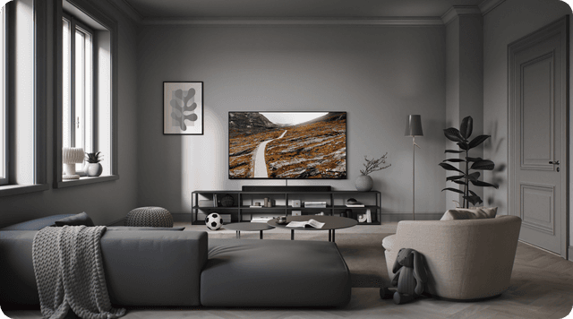 Samsung QLED -televisio hämärästi valaistussa harmaassa olohuoneessa