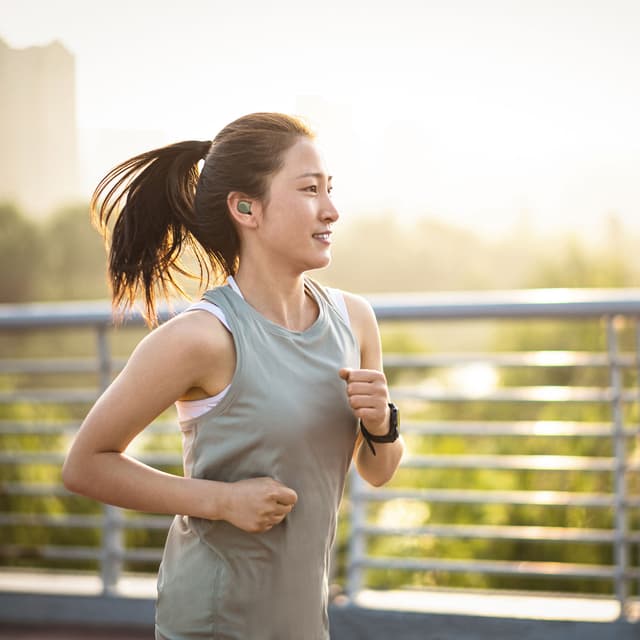 Jabra - Headphones - Female running outside with Jabra Elite 8 Active G2 in her ears