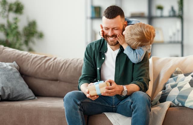 Man receiving a present from his son on Father's Day