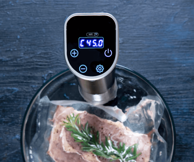 Sous vide - Space-Saving and precise circulator and vacuum packed meat with herbs