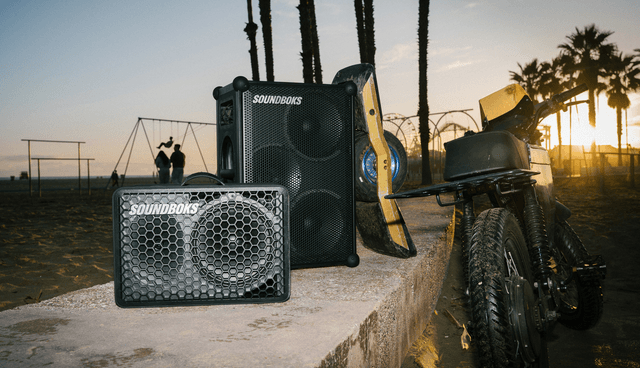 Soundboks speakers in a sunset next to a motorcycle