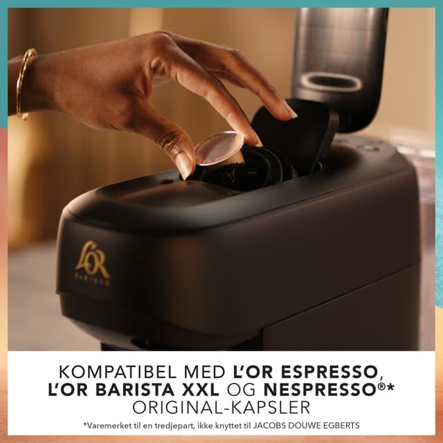 L’Or Absolu capsule machine on kitchen counter with the capsule compartment open