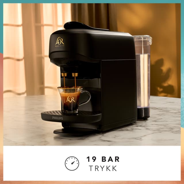 L’Or Absolu capsule machine on kitchen counter brewing a cup of coffee at a 19 bars brewing pressure