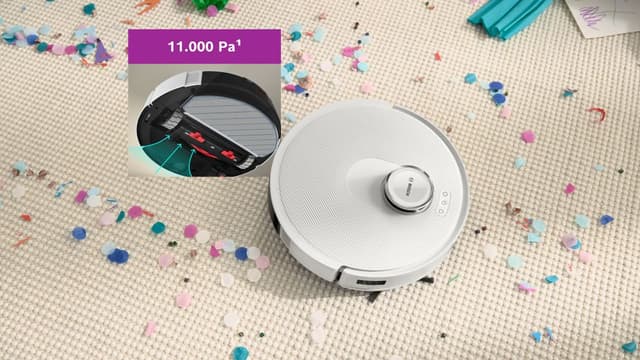 Robottipölynimuri siivoaa askartelun jälkiä matolta tehokkaalla imuvoimalla