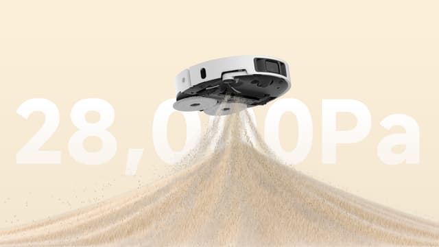 Illustrasjon av en Dreame L50 Ultra AE-rengjøringsrobot som svever i luften og suger opp sand.