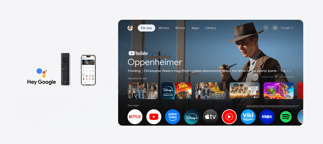 Kaukosäädin ja älypuhelin television vieressä, jossa näkyy Google TV:n käyttöliittymä suoratoistosovelluksi