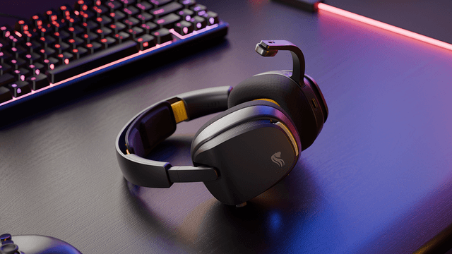 Trådløst Glorious GHS-headset på et bord ved siden av et gamingtastatur