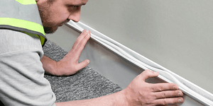 CE - Cables - Man installing a D-line Cable chanel