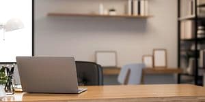 Laptop on a wooden desk in modern work space