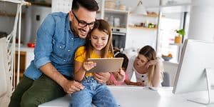 Man and girl looking at tablet