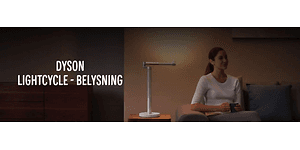 Dyson Lightcycle banner med kvinna som sitter i en soffa med sidobord och en bordslampa bredvid. 