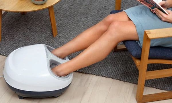 SDA - Massasje - Kvinne sitter i en stol og bruker YouCare fotmassasje