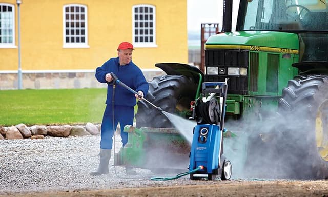 Man washing his tractor with Nilfisk pressure washer