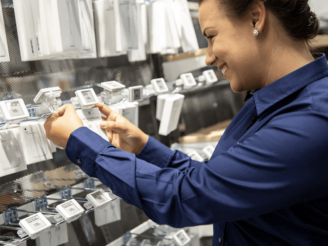 Corporate - Sustainabillity - Salesperson merchandising cables in store