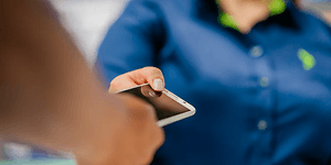 Corporate - Sustainabillity - customer handing over a phone
