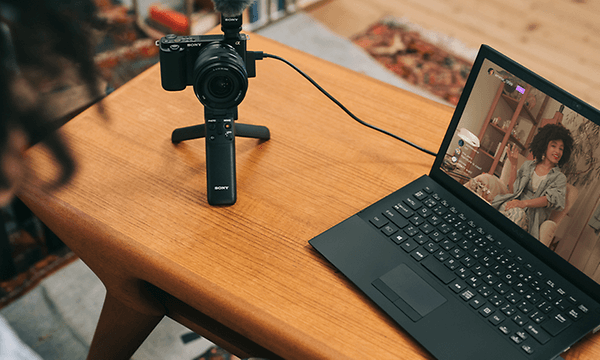 Sony ZV - Photo - Camera on a small tripod next to computer