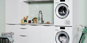 Washer and dryer in a laundry room with white and green interior