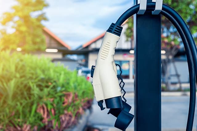 An EV-charger hanging in front of a house