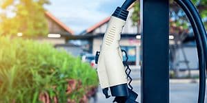 An EV-charger hanging in front of a house