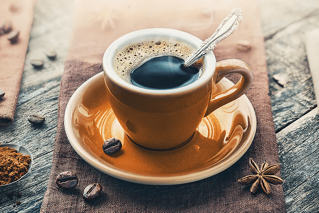 Espressokuppi, ympärillä kahvipapuja