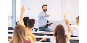 Airthings Wave Plus on a classroom wall behind teacher and students