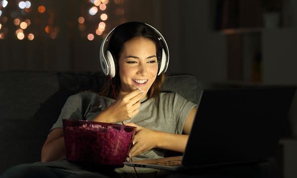 Woman watching a movie on a laptop