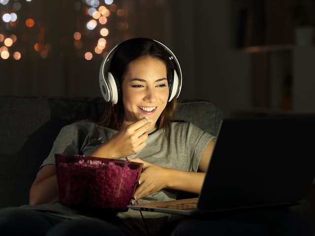 Woman watching a movie on a laptop