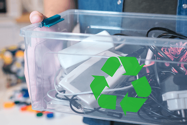 Sustainability - Recycling - A man holding a box with old electronics and a recycle logo
