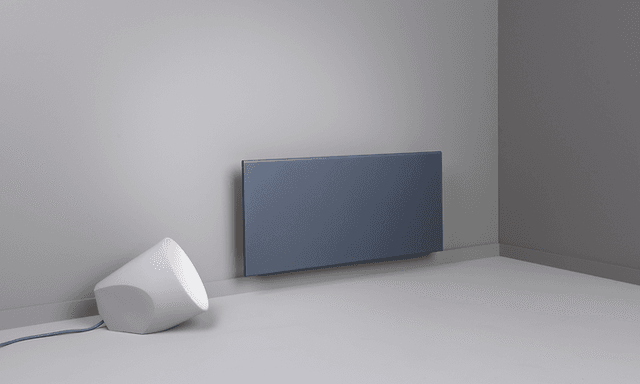 Black smart heater on a grey wall