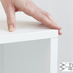 Epoq - Click - Hand pressing down on a white cabinet - Three Spine logo in corner
