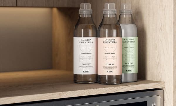 Detergent bottles on a washing machine from Asko