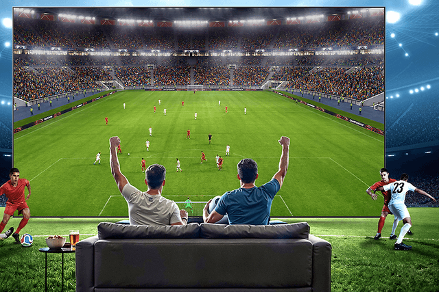 Familie i sofa ser på sport på TV