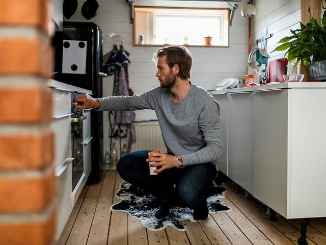 Man checking the oven