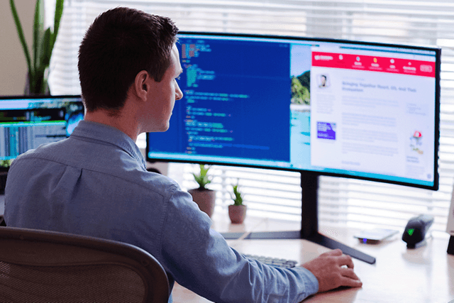 man sitting in front of pc screen
