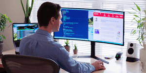 man sitting in front of pc screen