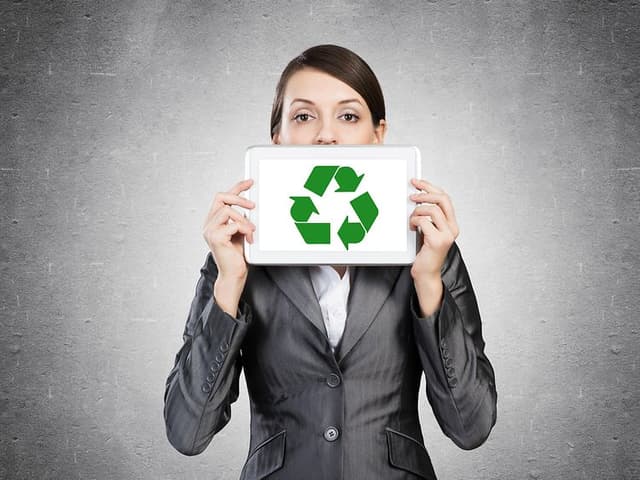 Woman with pad with recyle symbol