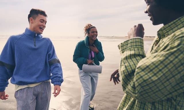 Sony-People walking on beach with Sony speaker