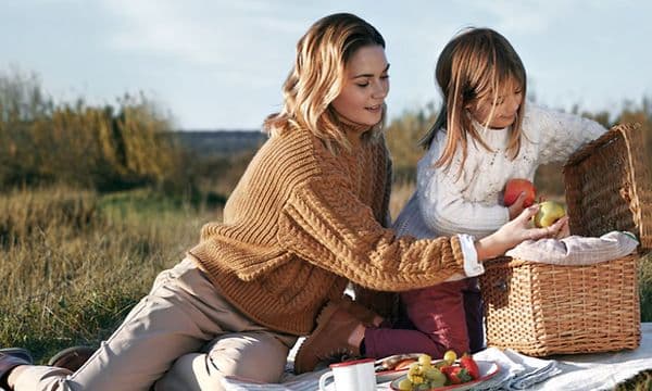 Woman and a little girl having a picnic outside