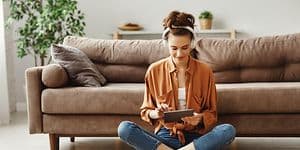 Woman sitting on floor using a tablet