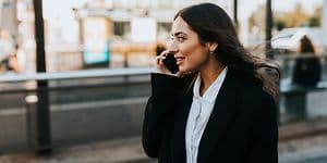 Woman walking on the street while she is having a phone call