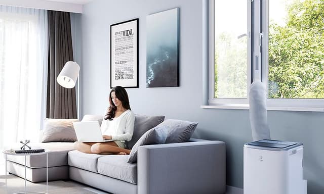 Elecotrulux -Air quality-Portable air conditioner beside a woman in couch