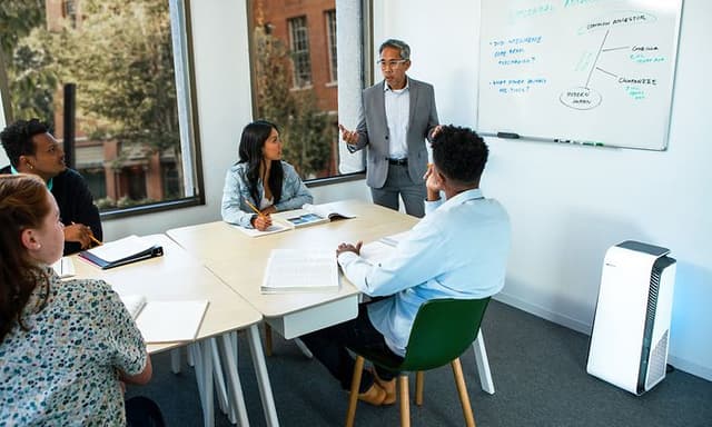 People in a office with a Blueair air purifier in the room