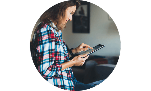 Woman in living room looking at tablet