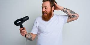 Man singing into hair blower
