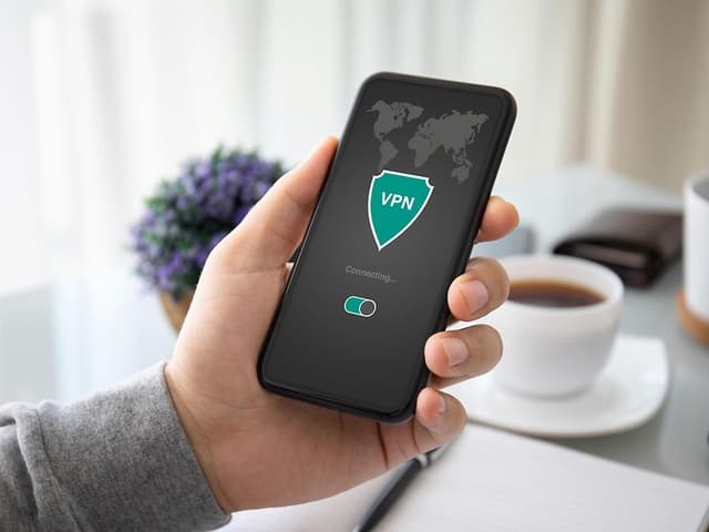 Hand holding phone with VPN