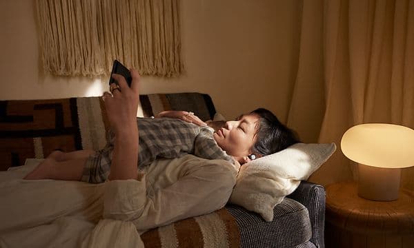 Woman with baby using Pixel Buds